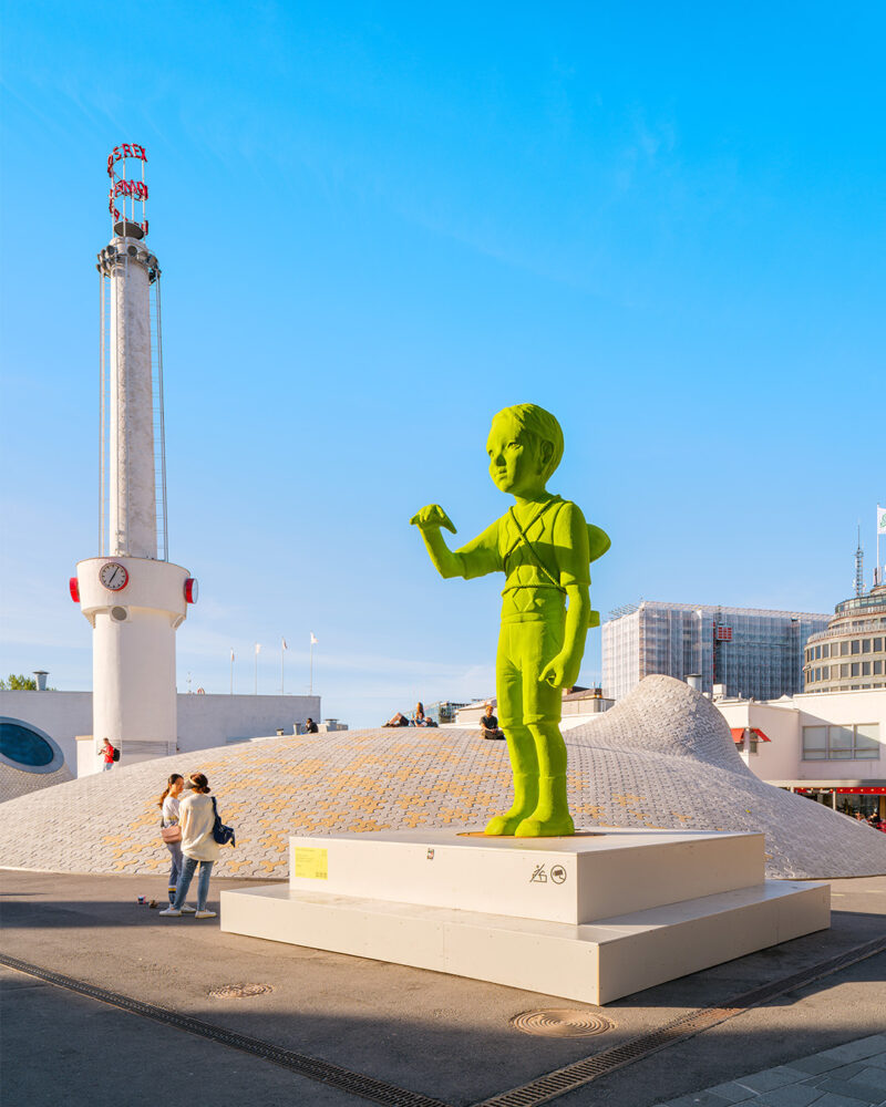 Over 3 meters tall moss giant boy stretches their arm forward.