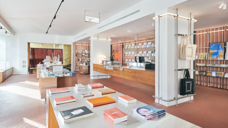 The Amos Rex Shop retail space. The photo shows display tables and products. The checkout counter is located between two pillars in the center of the shop.