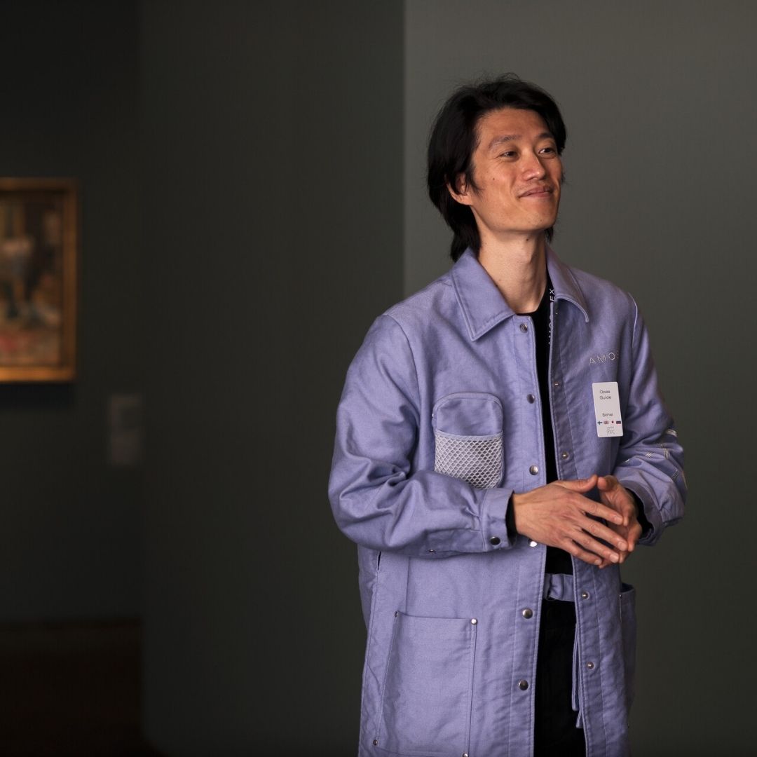 Amos Rex staff wear black shirts and lavender-colored jackets.