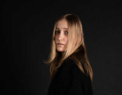 The artist is looking at the camera.