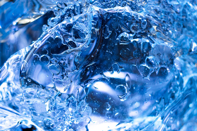 Water and droplets swirl in a blue vortex.