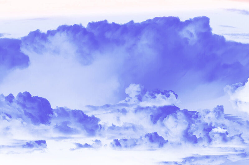 Cloud front in shades of blue approaches the viewer.