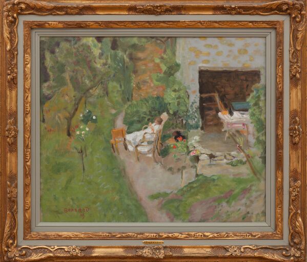 In the painting, a figure dressed in white is resting on a chair in a lush garden.