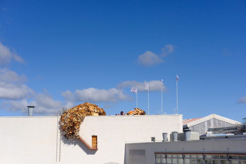 Photo of the artwork Nest. Picture shows how the Nest has spread on Amos Rex rooftop and cascading downwards.