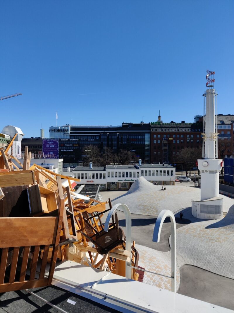 Tadashi Kawamata’s Nest installation spreads across the Amos Rex rooftop and over its edge, with countless chairs, shelves and wooden planks clustered together like a wriggling mass.
