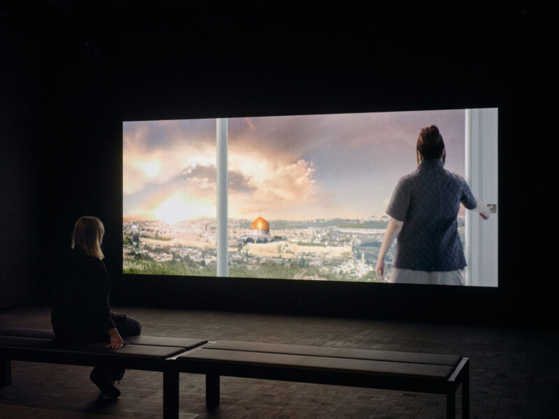 A visitor watches the video work Nation Estate.