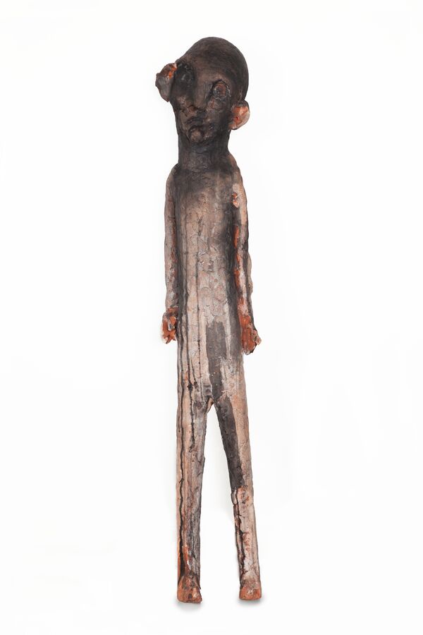 The image shows a ceramic figure by Tommi Toija.