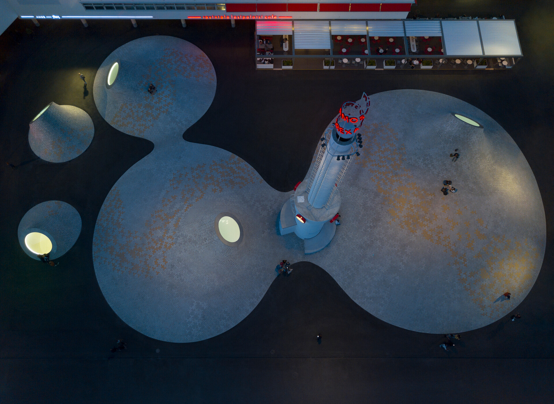 Amos Rex's concrete mounds photographed from above in the evening.