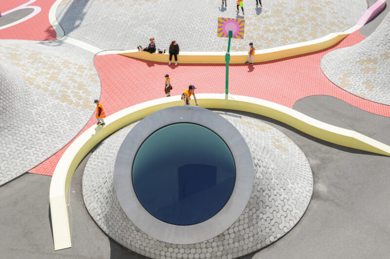 Children climbing Amos Rex's concrete mounds.